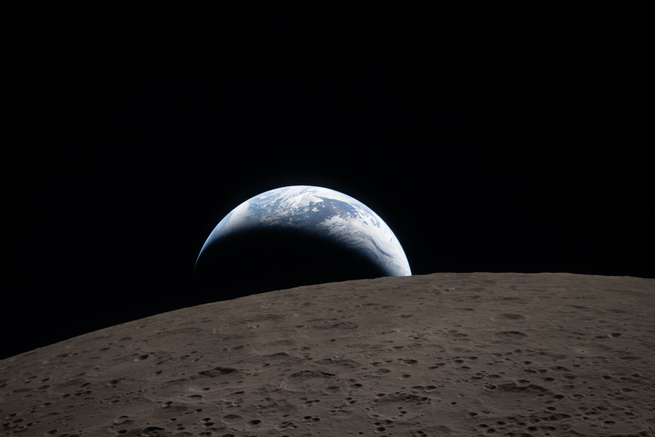 Серп Земли опускается за лунный горизонт на снимке экипажа Artemis II.